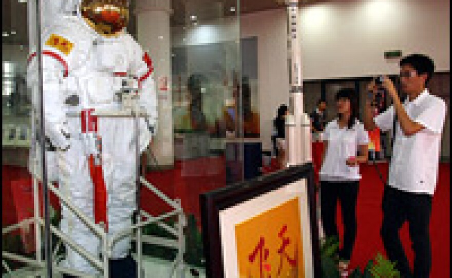 Visitors look at a spacesuit used by astronaut Zhai Zhigang during China's Shenzhou 7 mission before a space exhibition in Shanghai on June 28.