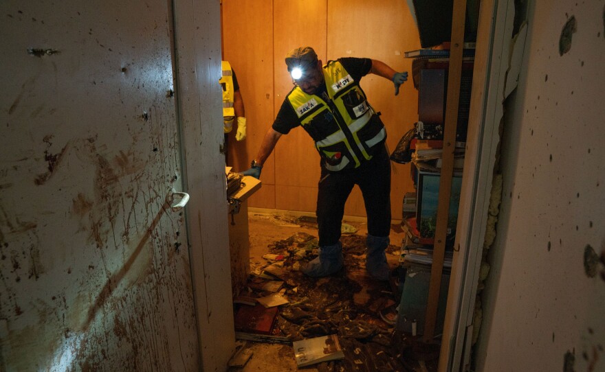 A team of Zaka volunteers clean up human remains from the Oct. 7 attacks in a home in Kfar Azza, Israel.