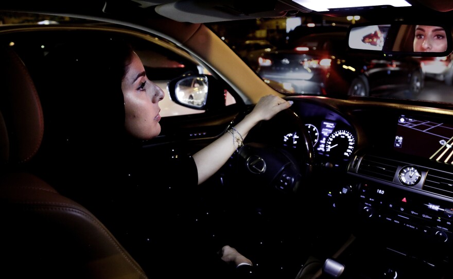 Hessah al-Ajaji drives down the busy Tahlia Street after midnight for the first time in Riyadh, Saudi Arabia, on Sunday.