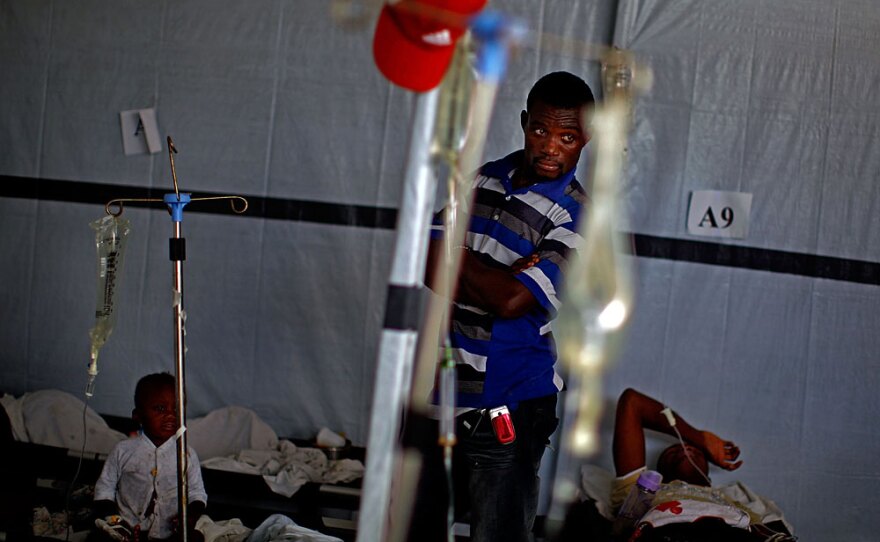 A man looks over a room of cholera victims in Port au Prince, Haiti, Dec. 10