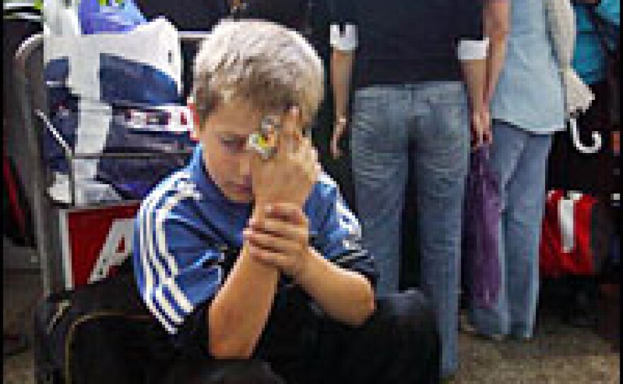 A boy waits to board a plane to Russia from the Tbilisi airport in October 2006. Moscow expelled 119 citizens of Georgia during a political confrontation with the former Soviet republic.