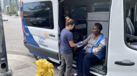 Kristan Horney, a nurse practitioner with Father Joe's Villages street health program, assisting a patient in a 2019 photo. 