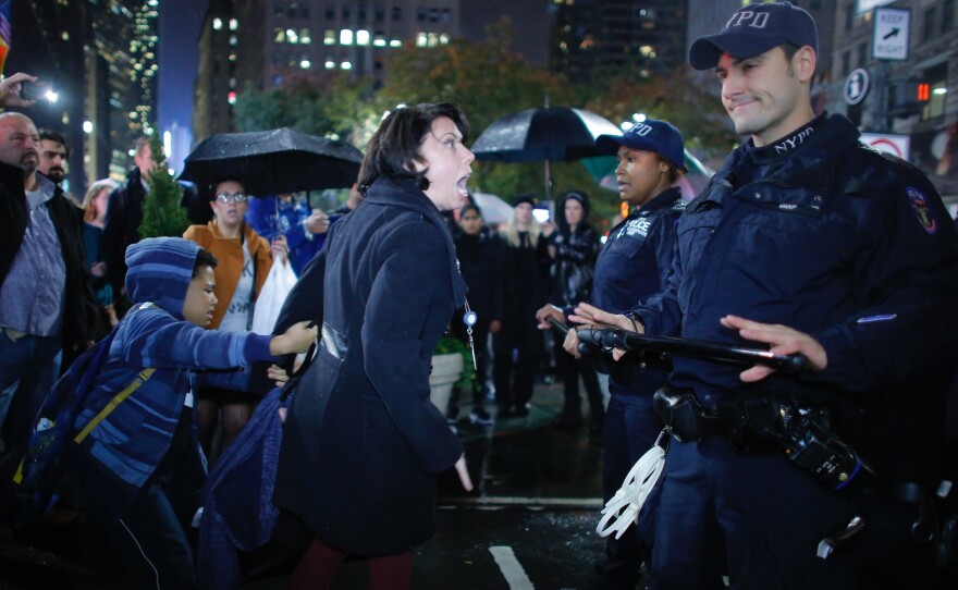Erin Michelle Threlfall argues with NYPD officers at a protest against President-elect Donald Trump in New York City on Wednesday.