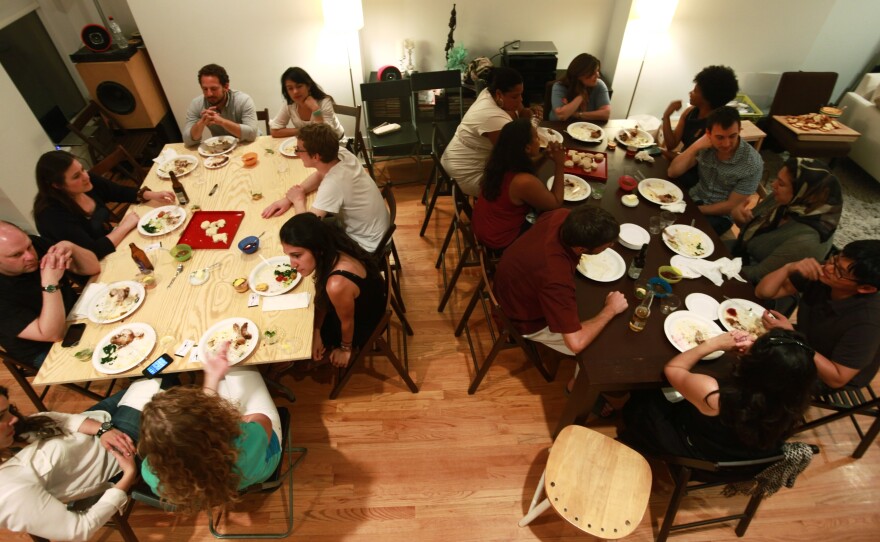 A group gathers in a Ballston, Va., home for a supper club organized through the site Feastly. A new food trend gaining popularity in New York and other cities lets diners enjoy a meal prepared by a stranger in that person's home.