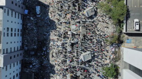 Residents and rescue workers search through the rubble after an earthquake struck Cali, Colombia, Monday, Aug. 10, 2026.