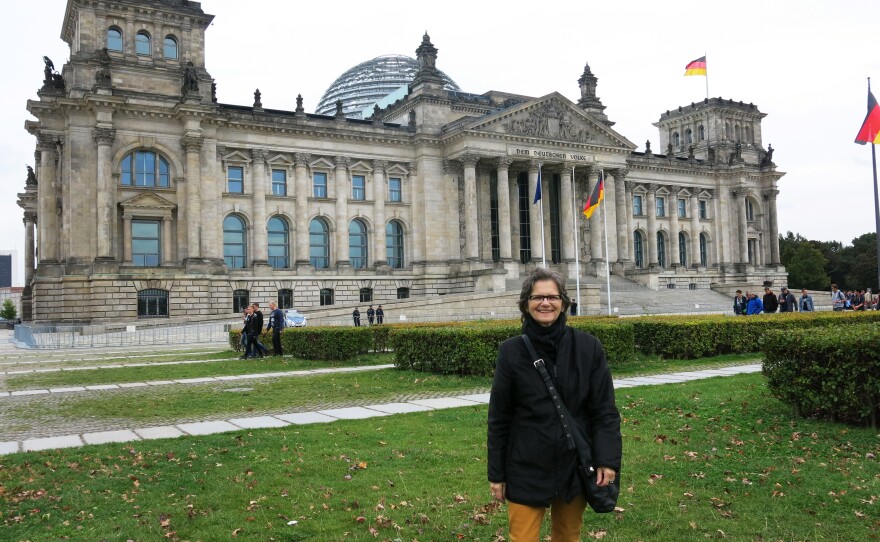 Annalie Schoen in front of the German Parliament building in Berlin. She is a West German transplant who helped create a seamless capital since lawmakers moved the government from Bonn back to Berlin in 1991.
