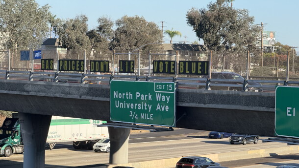 Letters spelling out the phrase, "Gas prices don't lie. Vote blue," are displayed on the Meade Avenue bridge over Interstate 805 on Oct. 8, 2026.