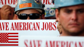 Workers hold up signs supporting lifting the moratorium on deep-water drilling during a rally at Gulf Island Fabrication last month in Houma, La. In June, a federal judge overturned the federal government's six-month moratorium on deep-water drilling, and refused to let the ban stay in effect while the government appeals.