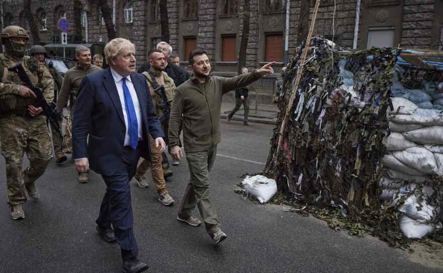 Ukrainian President Volodymyr Zelenskyy, center, and Britain's Prime Minister Boris Johnson walk in downtown Kyiv, Ukraine, in April . Johnson may have been shown the door in Britain, but he remains a popular figure in Ukraine, where he is admired for his support for the country's effort to repel the Russian invasion.