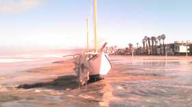 During overnight storm a sailboat washed up on South Mission Beach in San Diego on Sunday, Feb. 27.