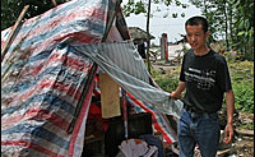 Mao Yun Cheng sleeps in a make-shift tent after losing his house in the quake.