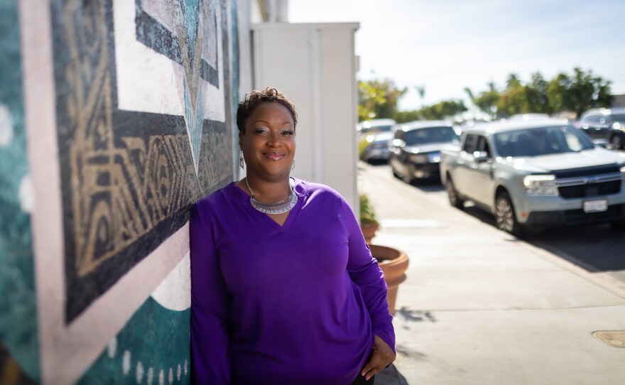 LaShae Sharp-Collins leans against a mural in this undated image.