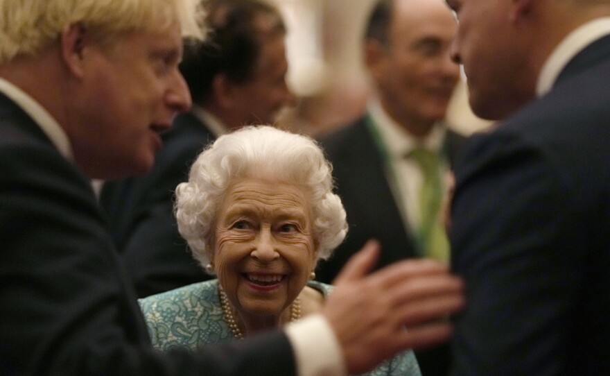 Britain's Queen Elizabeth II and Prime Minister Boris Johnson, left, greet guests at a reception at Windsor Castle, Windsor, England, Oct. 19, 2021.