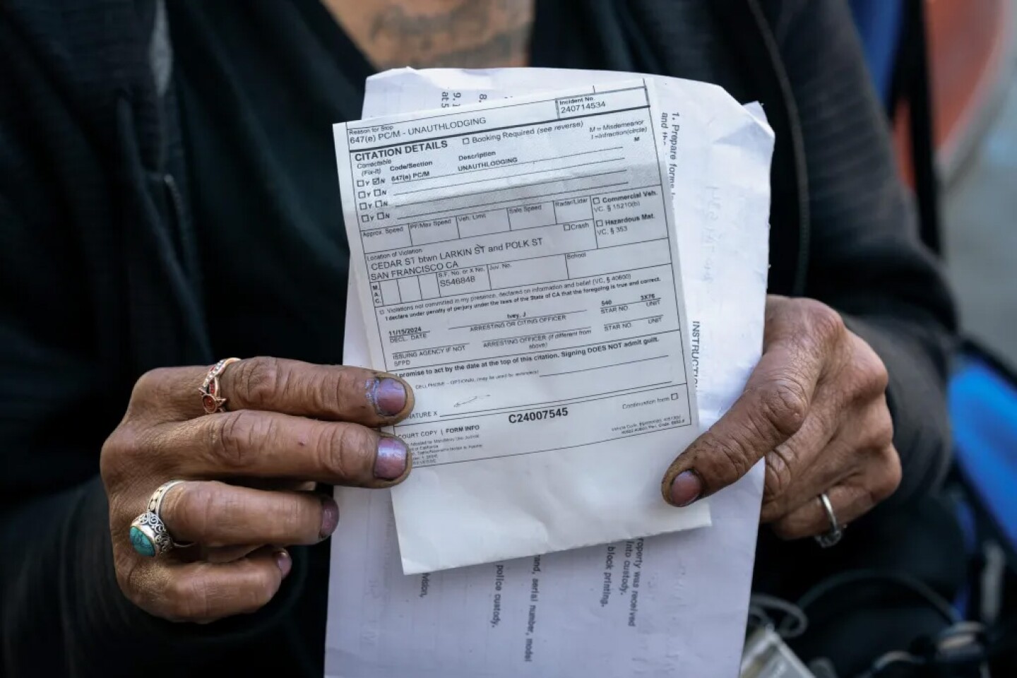 Linda Vazquez holds a citation for ‘unauthorized lodging’ from the San Francisco Police Department in San Francisco on Nov. 15, 2024.