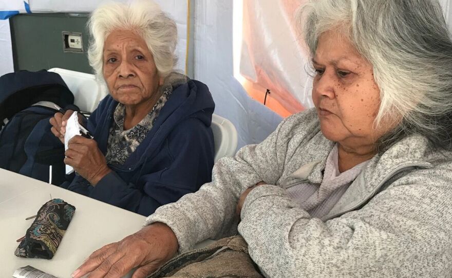 During recent blackouts in California, people like Fern Brown (left) and her sister, Lavina Suehead, came to a pop-up community center at the Auburn, Calf., fairgrounds to use electricity. Brown, 81, needed a treatment for her chronic lung condition.