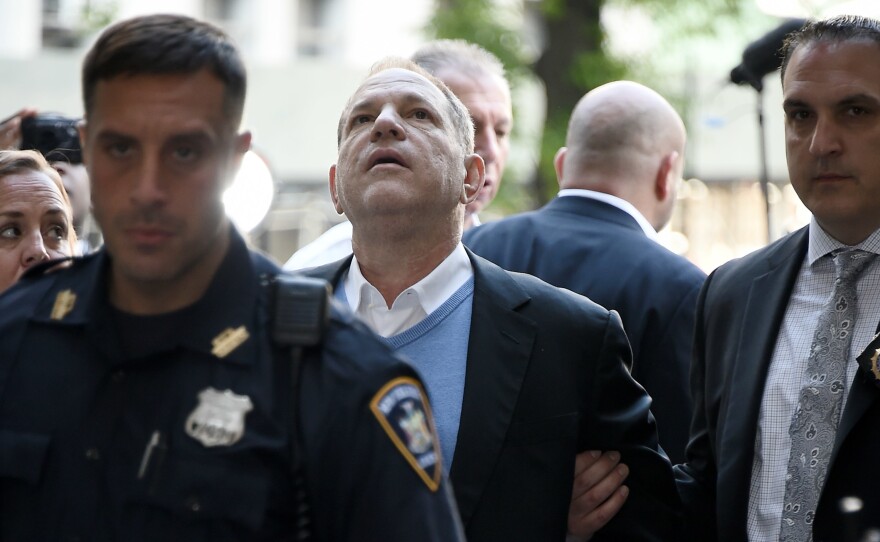 Law enforcement officers usher a handcuffed Harvey Weinstein into the courthouse for his arraignment in Manhattan on Friday.