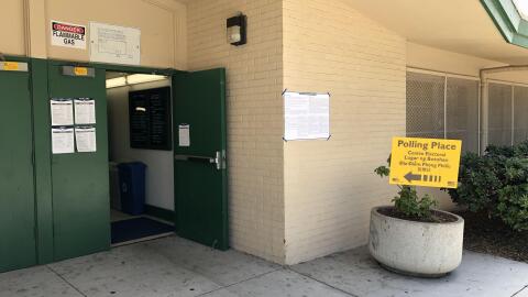 A sign showing a polling location in San Diego is displayed, June 5, 2018.
