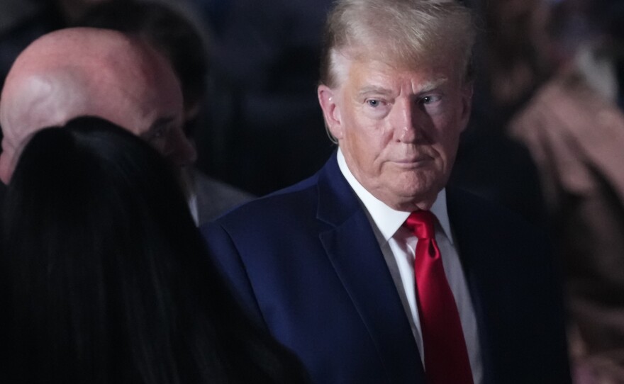 Former President Donald Trump, shown here at a mixed martial arts event on Nov. 11, is asking to be freed from a gag order in an election interference case.
