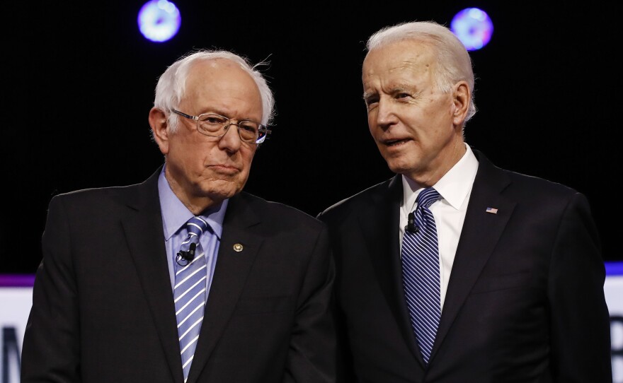 Democratic presidential candidates, Sen. Bernie Sanders,and former Vice President Joe Biden, talk before a the February Democratic presidential primary debate.