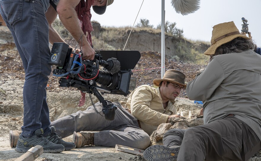 Ian Kellett (DOP), Robert De Palma, David Burnham, filming the uncovering of a fossil in Tanis, Landscape. (undated photo)