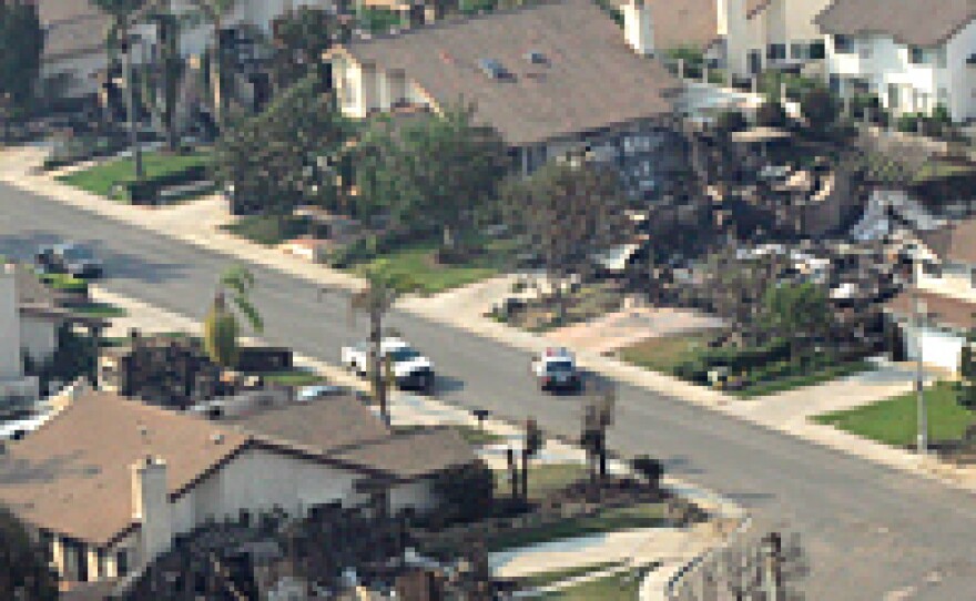 Marine One, with President Bush and California Gov. Arnold Schwarzenegger aboard, flies over wildfire damage on an aerial tour of Rancho Bernardo, Calif. Bush pledged support to help rebuild devastated areas.
