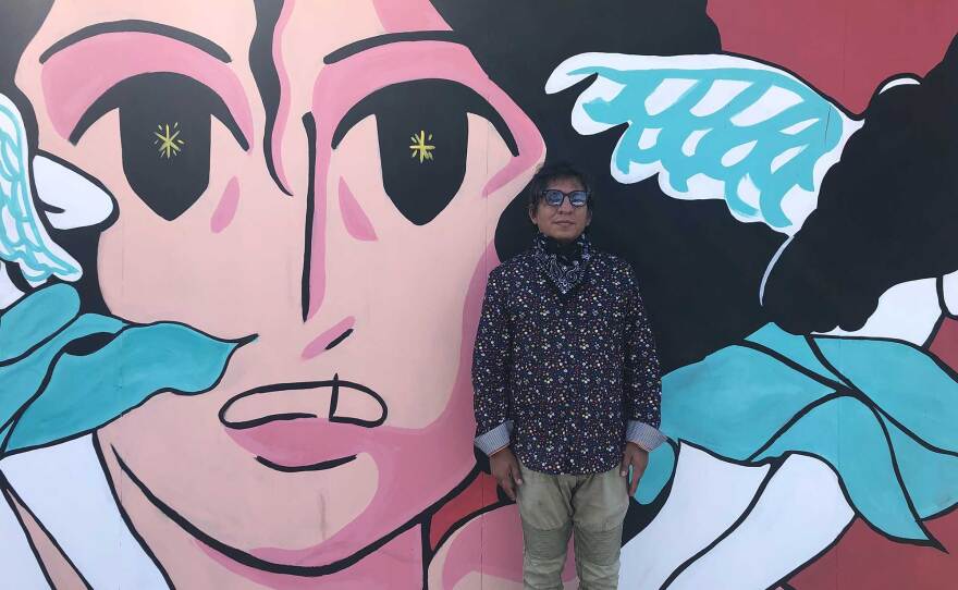 The Front gallery director Francisco Morales stands in front of Fifí Martínez's mural on September 25, 2020. The work is part of a seven-artist collaboration across the border.