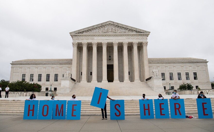 Activists hold a banner in front of the Supreme Court in Washington, D.C., on Thursday as the court rejected the Trump administration's move to rescind the Deferred Action for Childhood Arrivals program.