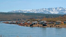 In this April 29, 2006, file photo, campers, cars and fisher people pack the south shoreline of Crowley Lake in Mammoth Lakes, Calif., for the opening day of fishing season. 