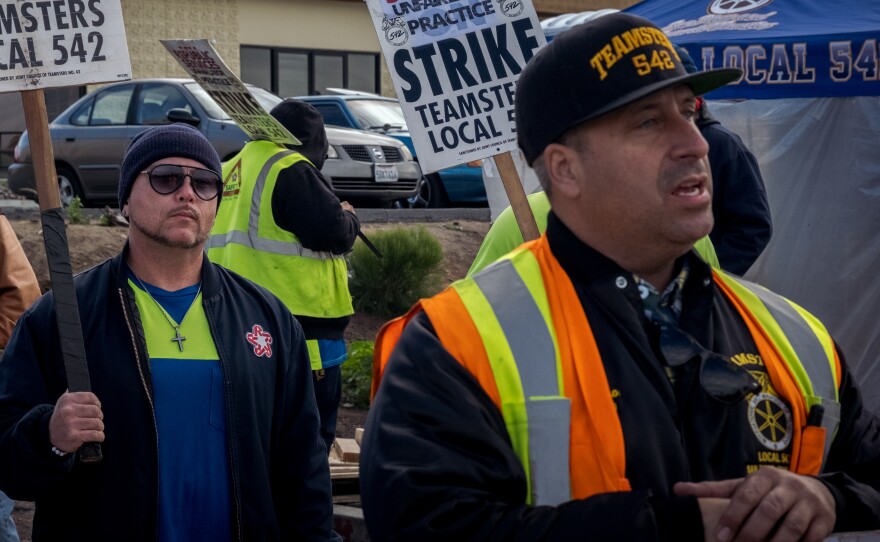 Teamsters Local 542 walk the picket line in front of Republic Services offices in off of Clairemont Mesa Blvd in San Diego on December 30, 2021.