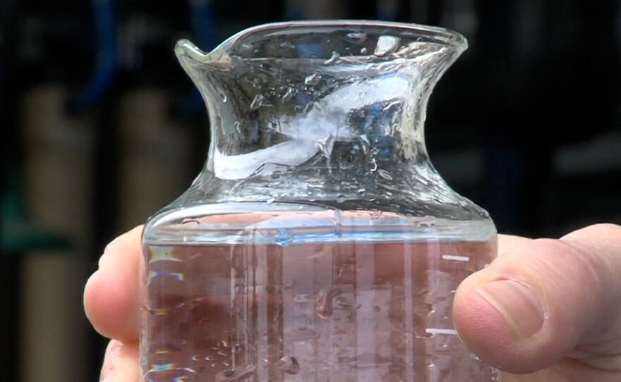 A carafe of clear water is shown being held in this undated photo.