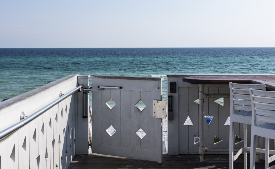 A gate grants keypad access to the beach near the Coleman Pavilion obelisk in Seaside.