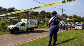 A police officer is seen at a scene of a mass shooting at a house party in KwaMakhutha township south of the city Durban, South Africa, Wednesday, Sept. 23, 2026.