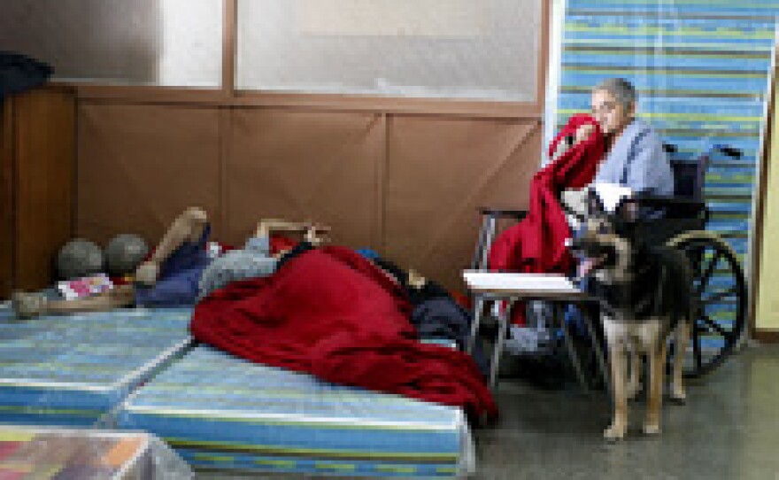 Residents gather in a shelter Sunday after a forest fire burned several neighborhoods in the hills of Valparaiso, northwest of Santiago.