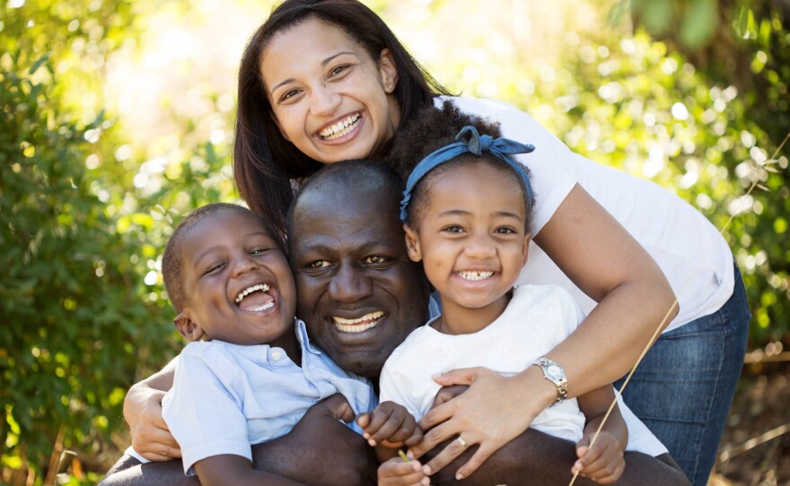 Carl Manlan, his wife, Lelani, and their two kids, Liam and Claire.