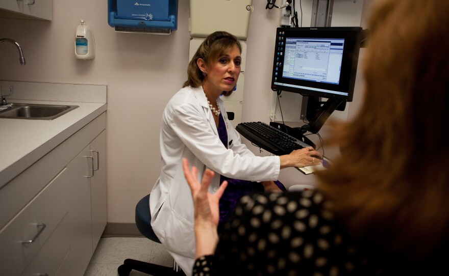 Andrea Singer, an OB-GYN at Georgetown University's hospital, discusses the HPV test with her patient, Robin Reath.
