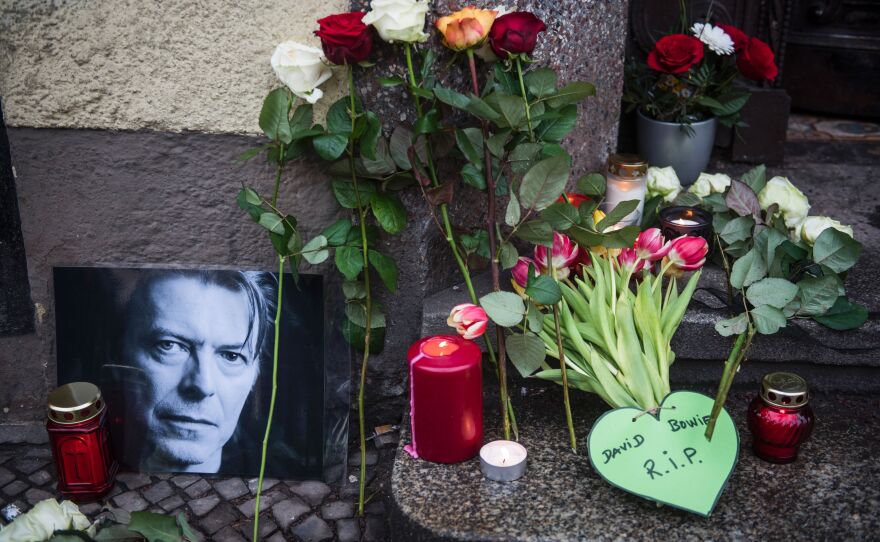 Tributes to the British rock legend are seen outside his former home in Berlin on Monday. Bowie died after a long battle with cancer, according to his official Twitter and Facebook accounts.