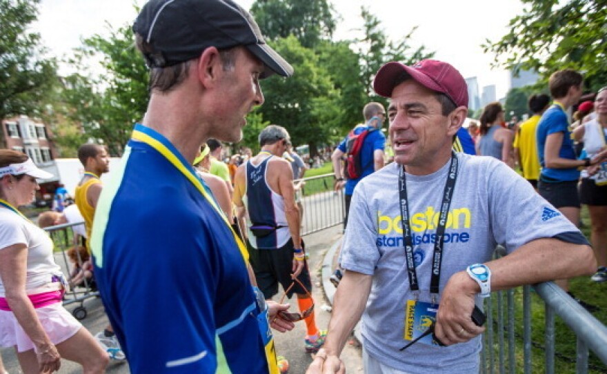 Boston Marathon Race Director Dave McGillivray, right, greeted runners during the Boston Athletics Association 10K race in Boston.
