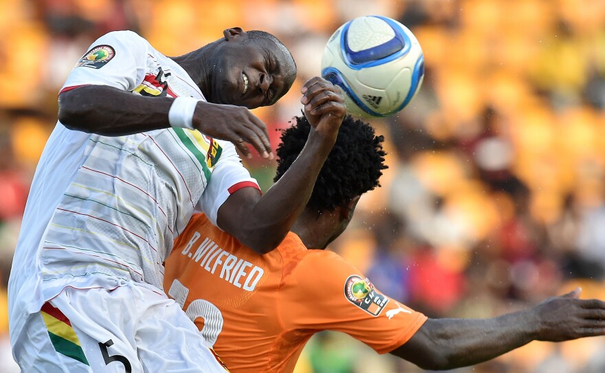 Guinea's defender Fode Camara (left) heads the ball over Ivory Coast's forward Wilfried Bony in the Africa Cup of Nations tournament.