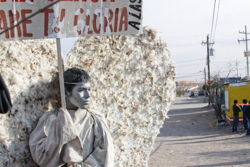 Young members of the evangelical church Psalm 100 in Ciudad Juarez dress as "messenger angels" to silently protest the Mexican city's ongoing violence. Here, 15-year-old Adan Ubacio Lopez holds a sign that translates to "Behold, I am here, Lord. I will bear your glory."