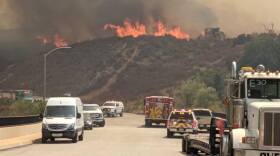 Firefighters work to extinguish the Tenaja Fire in Murrieta, September 5, 2019. 