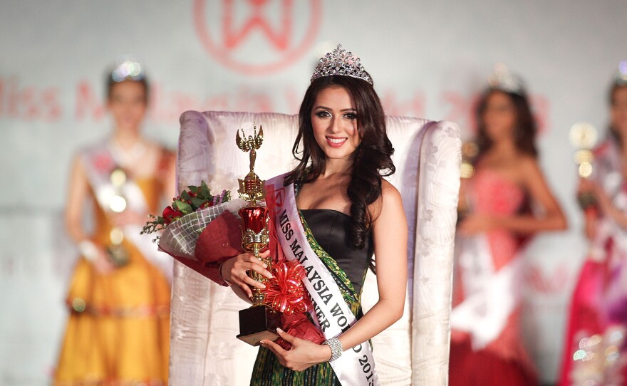 The winner of Miss Malaysia World 2013, Melinder Kaur Bhullar, poses during the grand finale on Aug. 2, 2013, in Kuala Lumpur, Malaysia. Four Muslim women were dropped as contestants after a religious decree, or fatwa,  barred them from participating.