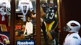 A fan gazes at Super Bowl XLIII merchandise in a Tampa, Fla., store window in advance of the 2009 game. Currently, Reebok has an exclusive contract to sell all of the NFL's merchandise, but that could change soon.