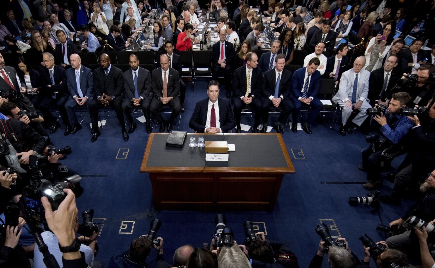 Former FBI Director James Comey takes his seat to testify at a Senate Intelligence Committee hearing on Capitol Hill on Thursday.
