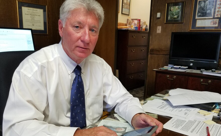 East Baton Rouge District Attorney Hillar Moore, who wants Apple or the FBI to unlock an iPhone 5s, has a stack of articles about encryption on his desk.