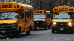 School buses idle in front of a school in Manhattan's East Village on Jan. 15, 2013.