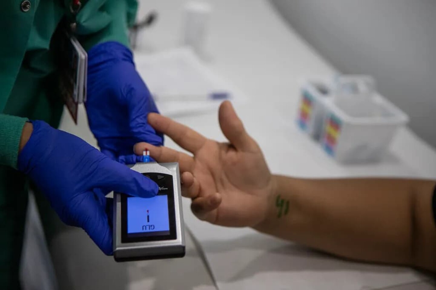 Dr. Navdeep Lehga checks a patient’s blood sugar in the exam room of the Saint Agnes Mobile Health Unit clinic, parked in the lot of Rojas Pierce Park in Mendota on Aug. 28, 2025.