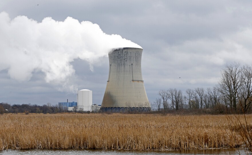 In this April 4, 2017, file photo, plumes of steam drift from the cooling tower of FirstEnergy Corp.'s Davis-Besse Nuclear Power Station in Oak Harbor, Ohio.