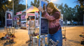 Raz Zarfati, sister of Ron Zarfati who was killed in the Oct. 7, 2023, Hamas attack on Israel, attend a memorial marking the third anniversary of the attack at the Nova music festival site near Kibbutz Reim, southern Israel, Wednesday, Oct. 7, 2026.