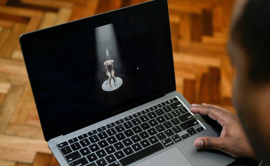 Víctor Navarro shows on his laptop part of the virtual reality tour of Venezuela's El Helicoide prison.