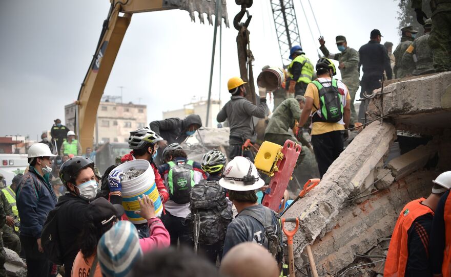 Volunteers remove rubble as they search for survivors in a flattened building in Mexico City on Wednesday.